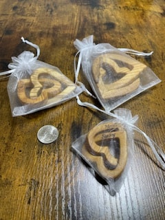 All three sizes of olive wood connected hearts in organza gift bags